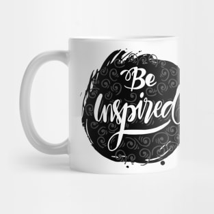 Be inspired phrase hand lettering with feathers. Mug